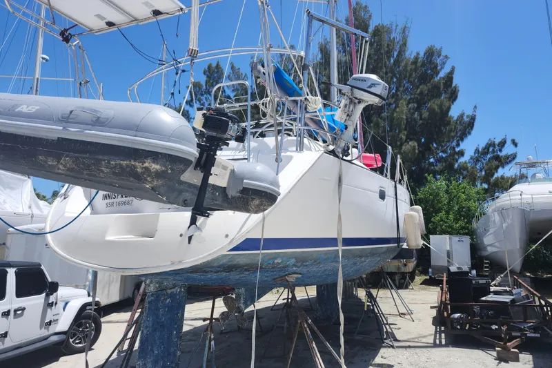 Slide: The Image of 2003 Beneteau 50 sailboat on dry dock with dinghy and outboard motor. - 5