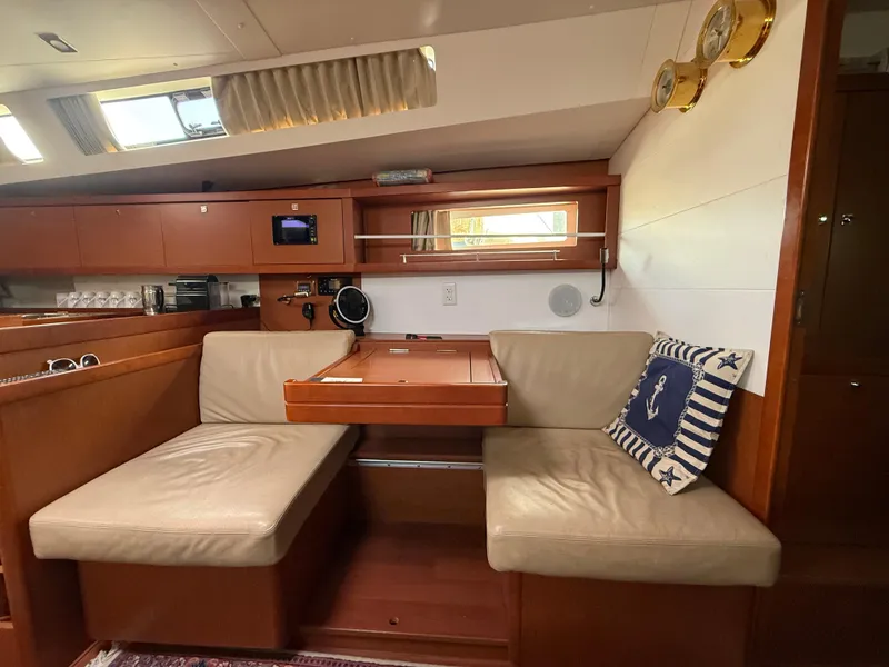 Slide: The Image of Interior of 2016 Beneteau Oceanis 45 yacht with cozy seating and nautical decor. - 1