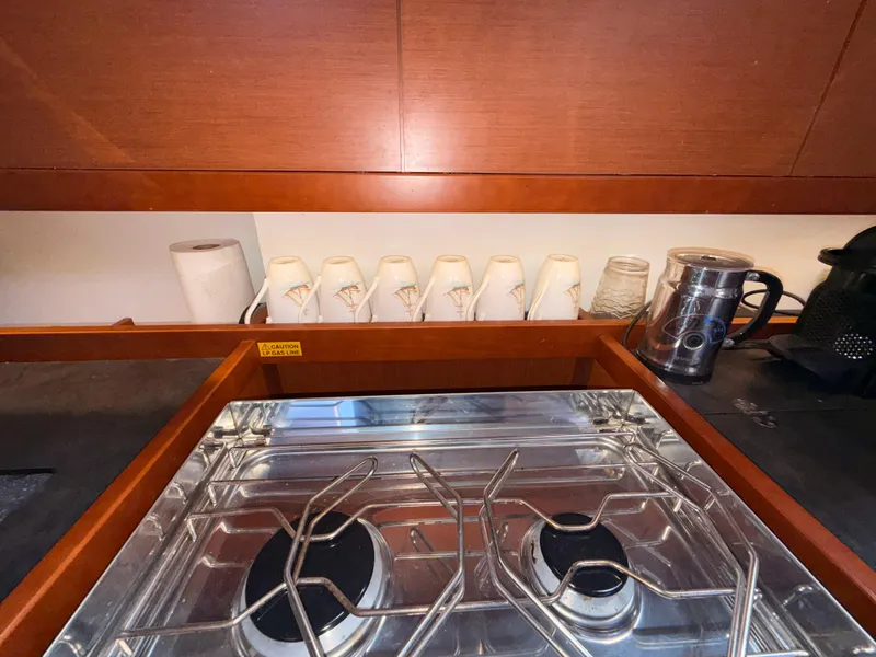 Slide: The Image of Galley kitchen in 2016 Beneteau Oceanis 45 yacht with stove and mugs. - 17