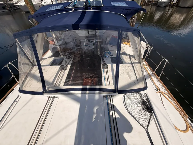 Slide: The Image of 2016 Beneteau Oceanis 45 sailboat with blue canopy docked at marina. - 23