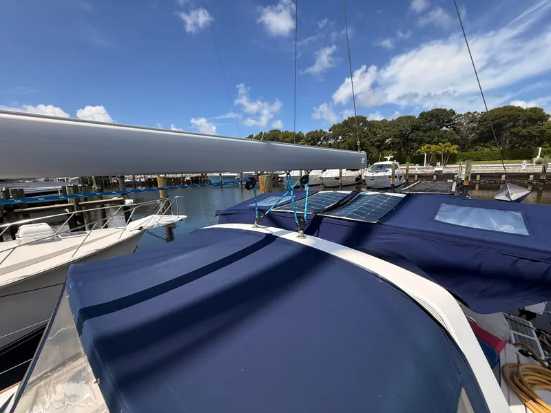 Slide: The Image of 2016 Beneteau Oceanis 45 sailboat docked, featuring solar panels and blue covers. - 26