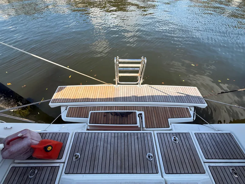 Slide: The Image of Beneteau Oceanis 45 (2016) swim platform with ladder, docked on calm water. - 27