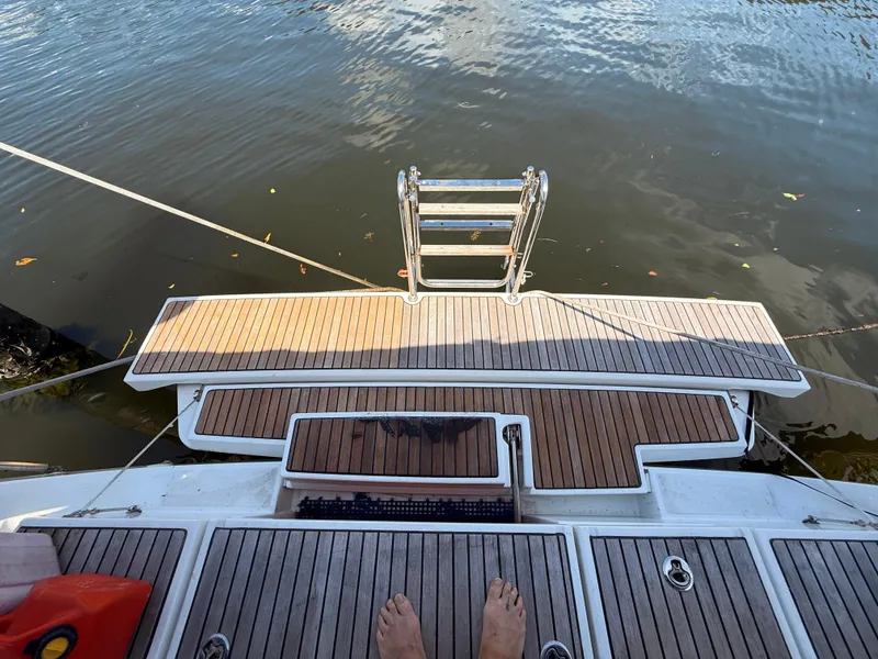 Slide: The Image of Beneteau Oceanis 45 yacht stern with teak deck and swim ladder, 2016 model. - 28