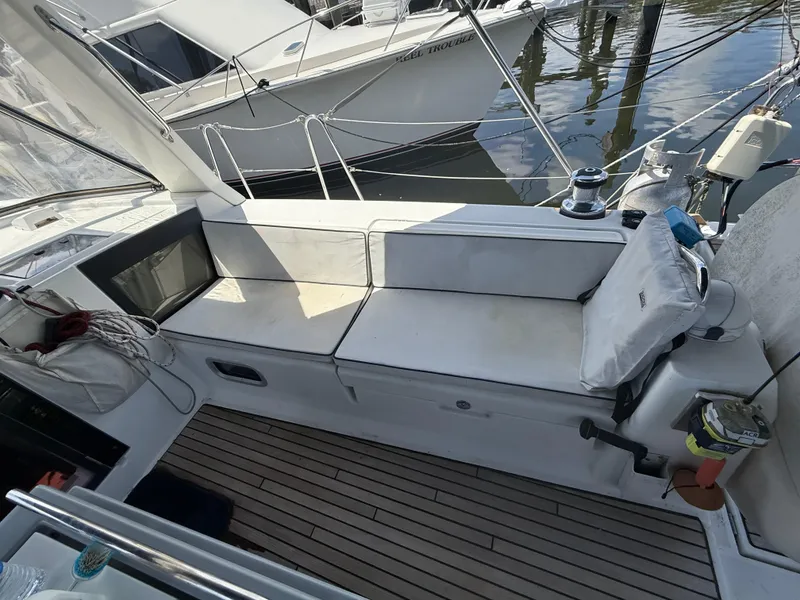 Slide: The Image of Cockpit of 2016 Beneteau Oceanis 45 sailboat with cushioned seating and nautical equipment. - 29