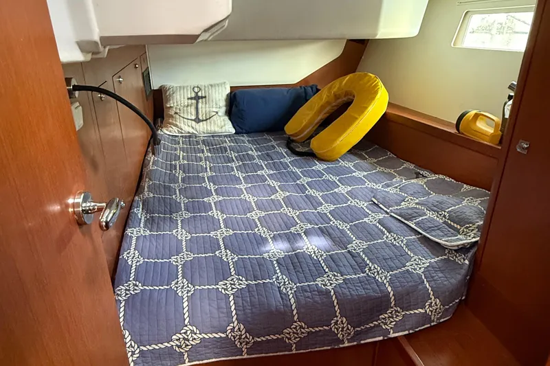 Slide: The Image of Cozy cabin interior of 2016 Beneteau Oceanis 45 with nautical-themed bedding. - 34