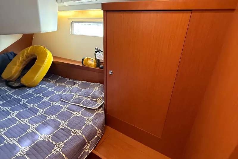 Slide: The Image of Cozy cabin interior of 2016 Beneteau Oceanis 45 with wooden cabinetry and patterned bedding. - 35