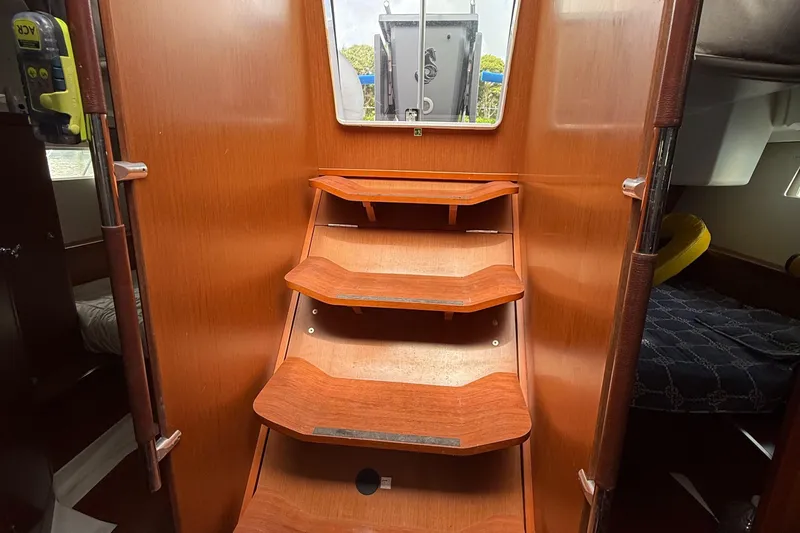 Slide: The Image of Interior wooden stairs of a 2016 Beneteau Oceanis 45 sailboat. - 36