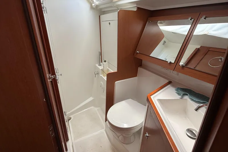 Slide: The Image of 2016 Beneteau Oceanis 45 yacht bathroom with wooden cabinetry and modern fixtures. - 37