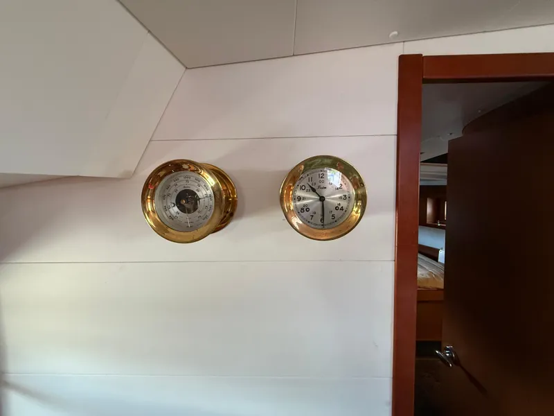 Slide: The Image of Interior of 2016 Beneteau Oceanis 45 yacht with brass clock and barometer on wall. - 4