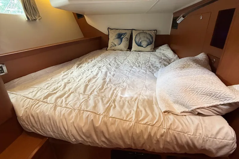 Slide: The Image of Cozy cabin bed in 2016 Beneteau Oceanis 45 yacht with shell-themed pillows. - 40