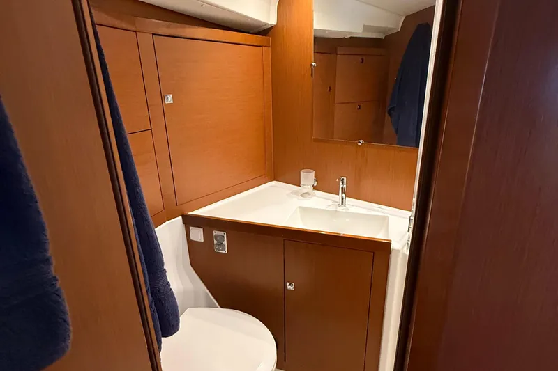 Slide: The Image of Bathroom interior of 2016 Beneteau Oceanis 45 yacht, featuring wooden cabinetry and modern sink. - 42