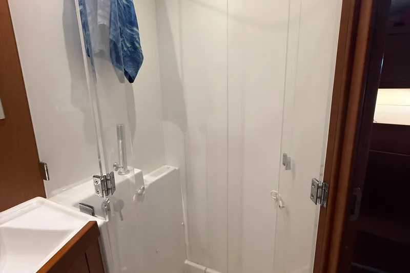 Slide: The Image of Bathroom interior of 2016 Beneteau Oceanis 45 yacht, featuring a shower and wooden accents. - 43