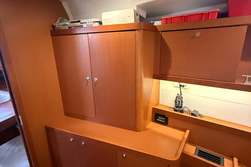 Slide: The Image of Interior of 2016 Beneteau Oceanis 45 yacht with wooden cabinetry and storage. - 44
