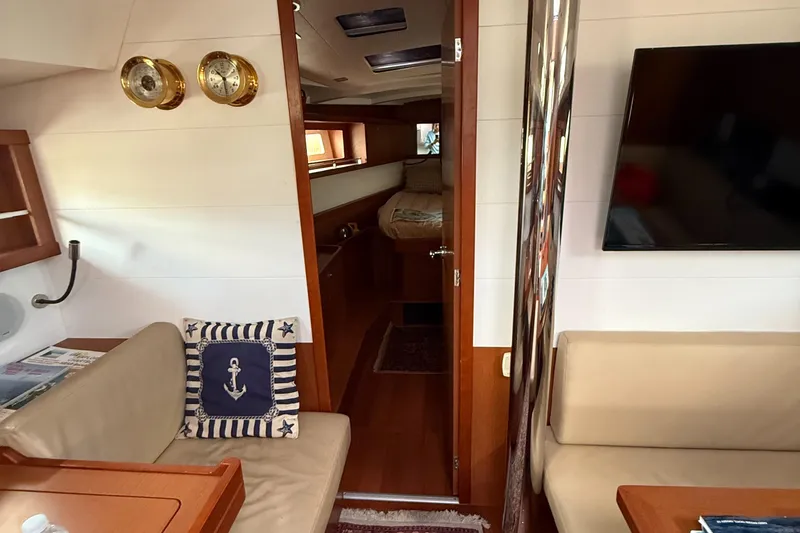 Slide: The Image of Interior of 2016 Beneteau Oceanis 45 yacht with cozy seating and nautical decor. - 46