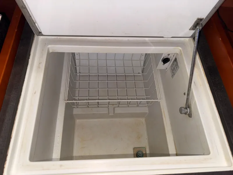 Slide: The Image of Open storage compartment on 2016 Beneteau Oceanis 45 yacht, featuring a wire basket. - 9