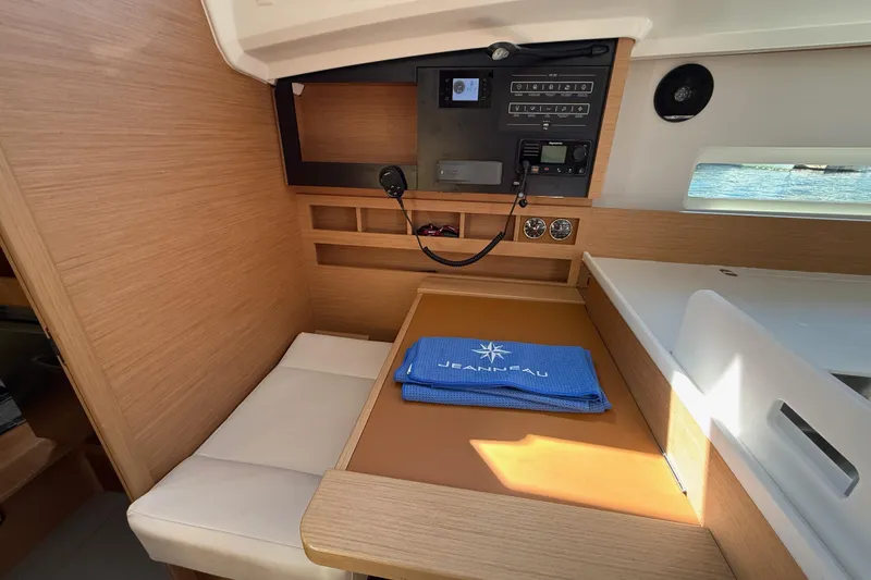 Slide: The Image of Interior of 2023 Jeanneau Sun Odyssey 410 yacht with navigation panel and seating area. - 11