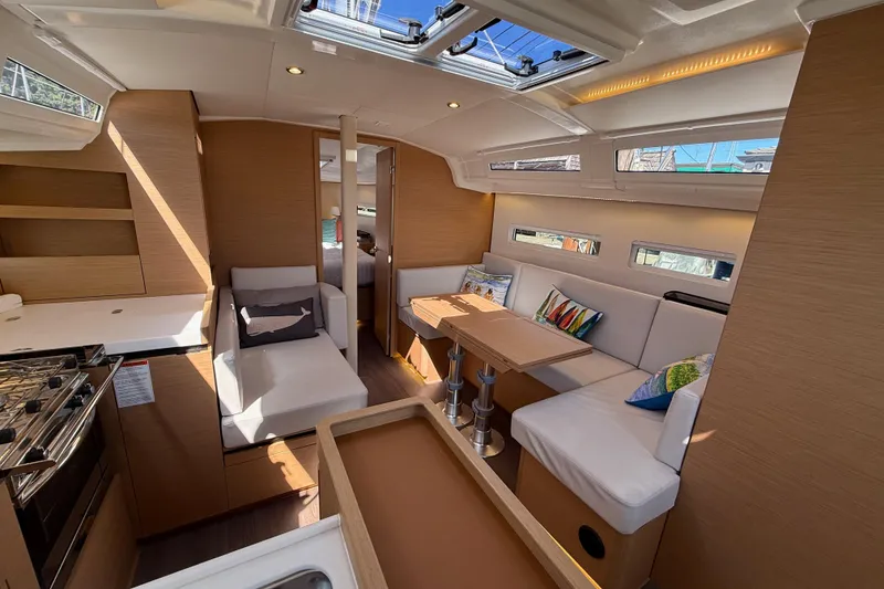 Slide: The Image of Modern interior of 2023 Jeanneau Sun Odyssey 410 yacht with cozy seating and dining area. - 12