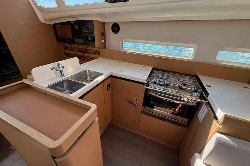 Slide: The Image of Modern kitchen in 2023 Jeanneau Sun Odyssey 410 yacht with stove and sink. - 13