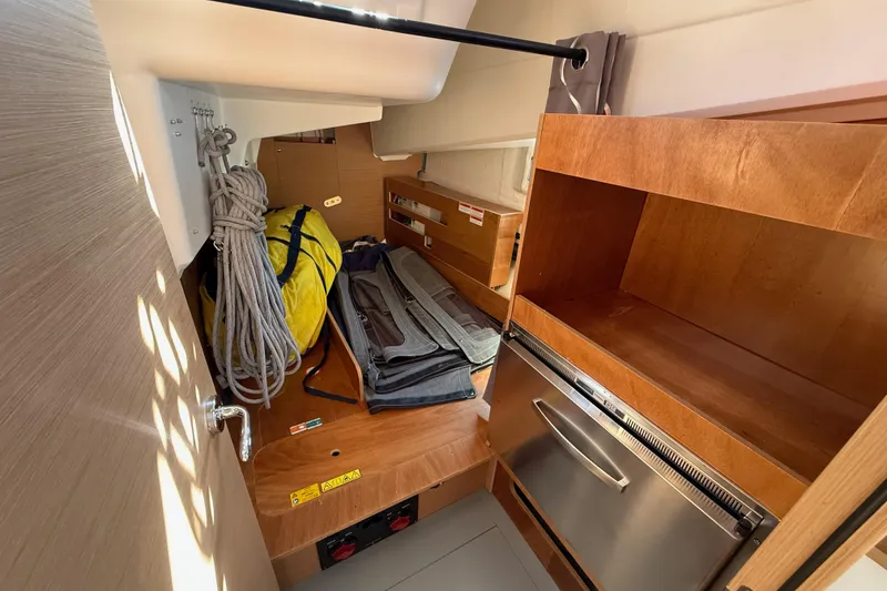 Slide: The Image of Interior storage area of 2023 Jeanneau Sun Odyssey 410 sailboat with ropes and equipment. - 15