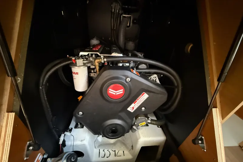 Slide: The Image of Engine compartment of 2023 Jeanneau Sun Odyssey 410 sailboat, showcasing mechanical components. - 16