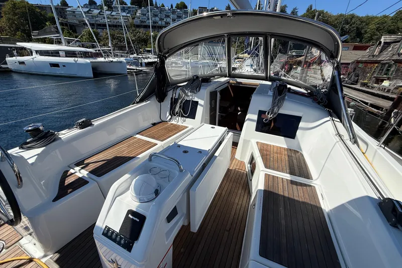 Slide: The Image of 2023 Jeanneau Sun Odyssey 410 sailboat cockpit with wooden flooring and modern design. - 2