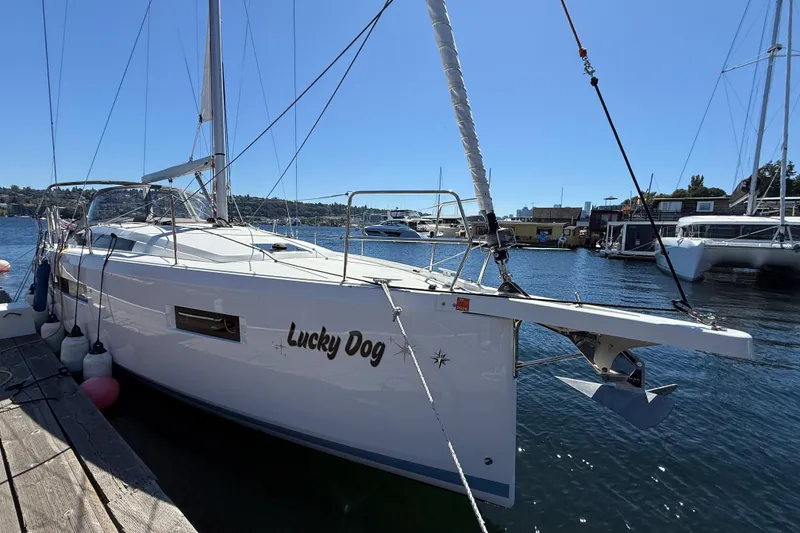Slide: The Image of 2023 Jeanneau Sun Odyssey 410 sailboat named "Lucky Dog" docked at a marina. - 23