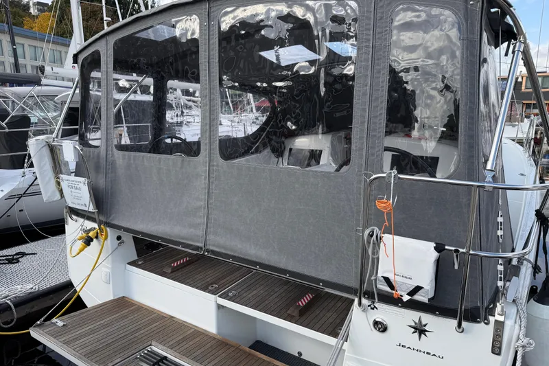 Slide: The Image of 2023 Jeanneau Sun Odyssey 410 sailboat with covered cockpit, docked at marina. - 26