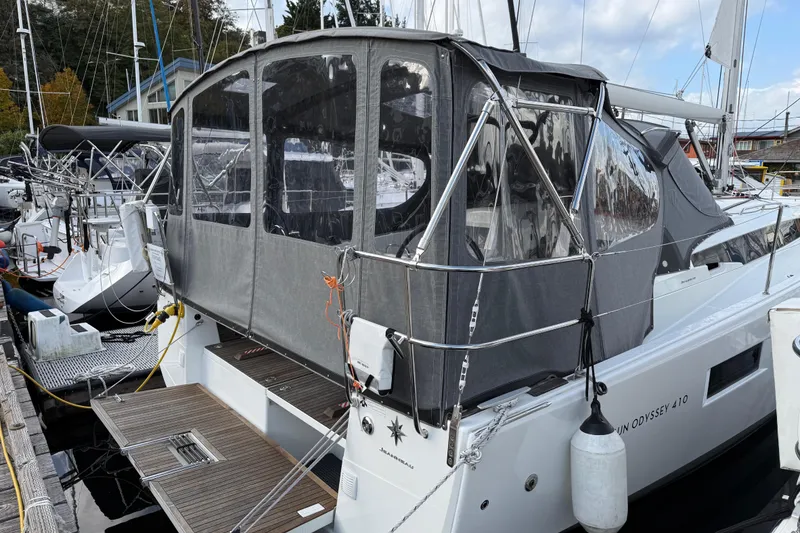 Slide: The Image of 2023 Jeanneau Sun Odyssey 410 sailboat docked with protective canopy. - 27