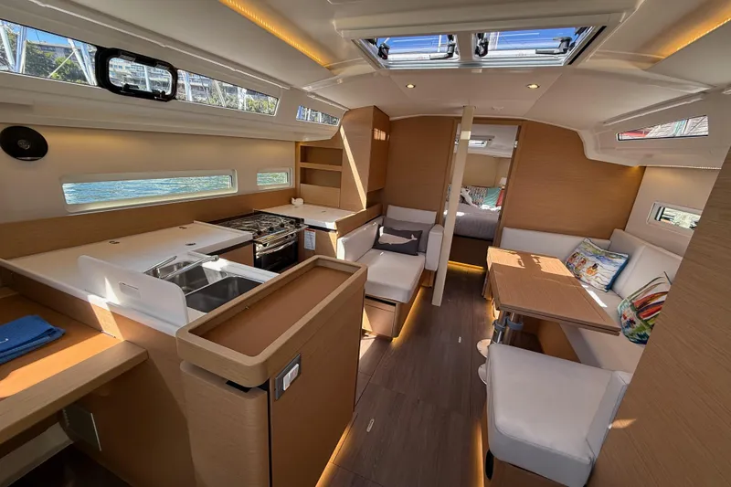 Slide: The Image of Luxurious interior of 2023 Jeanneau Sun Odyssey 410 sailboat with modern kitchen and seating area. - 3