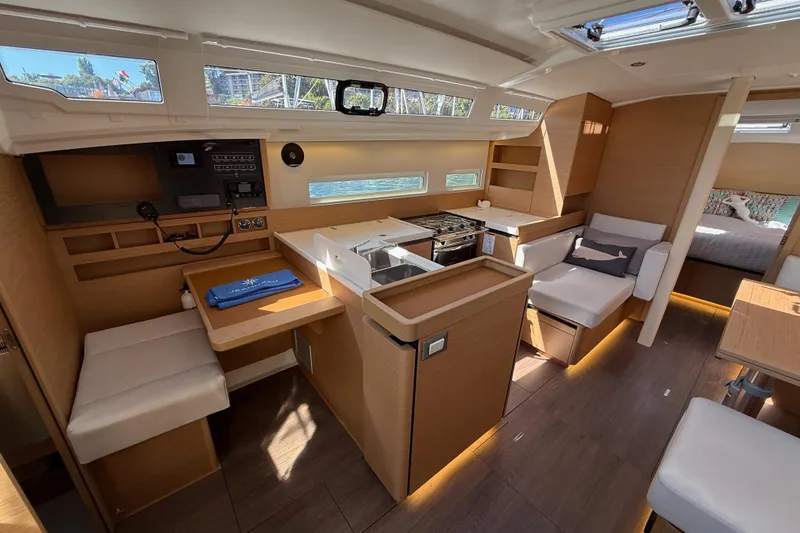 Slide: The Image of Interior of 2023 Jeanneau Sun Odyssey 410 yacht, featuring modern kitchen and seating area. - 5