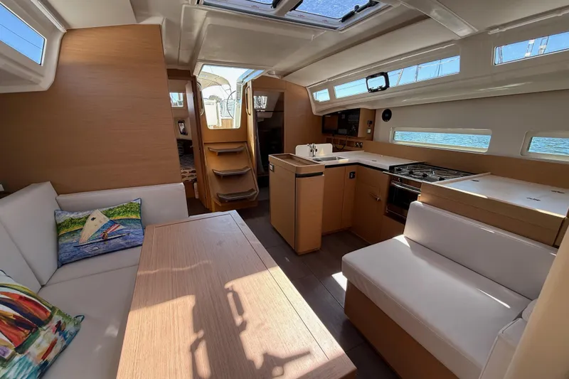 Slide: The Image of Interior of 2023 Jeanneau Sun Odyssey 410 yacht with modern kitchen and seating area. - 8