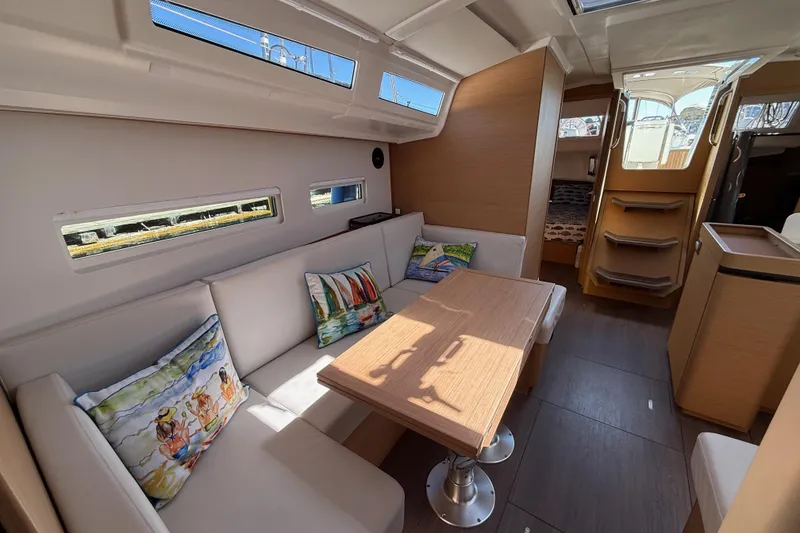Slide: The Image of Interior of 2023 Jeanneau Sun Odyssey 410 yacht with cozy seating and decorative pillows. - 9