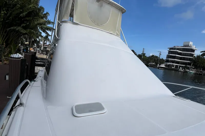 Slide: The Image of 2000 Luhrs Tournament 360 Convertible boat docked by waterfront buildings. - 10