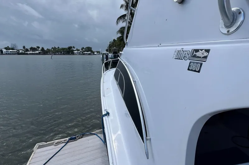 Slide: The Image of 2000 Luhrs Tournament 360 Convertible yacht docked by calm waters. - 19
