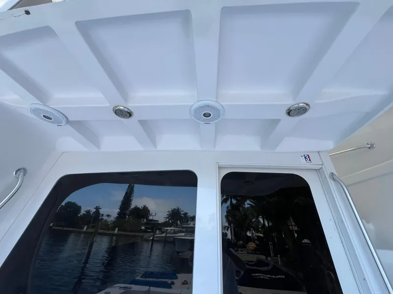 Slide: The Image of 2000 Luhrs Tournament 360 Convertible boat interior with ceiling lights and window view. - 20