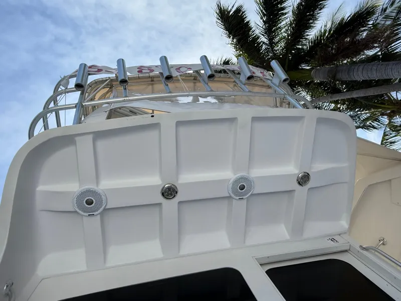 Slide: The Image of 2000 Luhrs Tournament 360 Convertible boat, viewed from below, with palm trees in the background. - 21