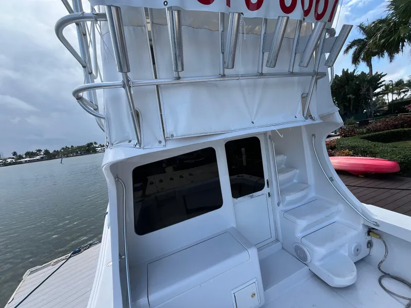 Slide: The Image of 2000 Luhrs Tournament 360 Convertible boat docked by the water, featuring a white exterior. - 22