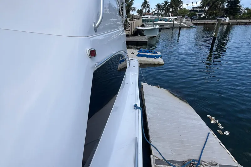 Slide: The Image of Luhrs Tournament 360 Convertible 2000 docked at marina with calm water and palm trees. - 24