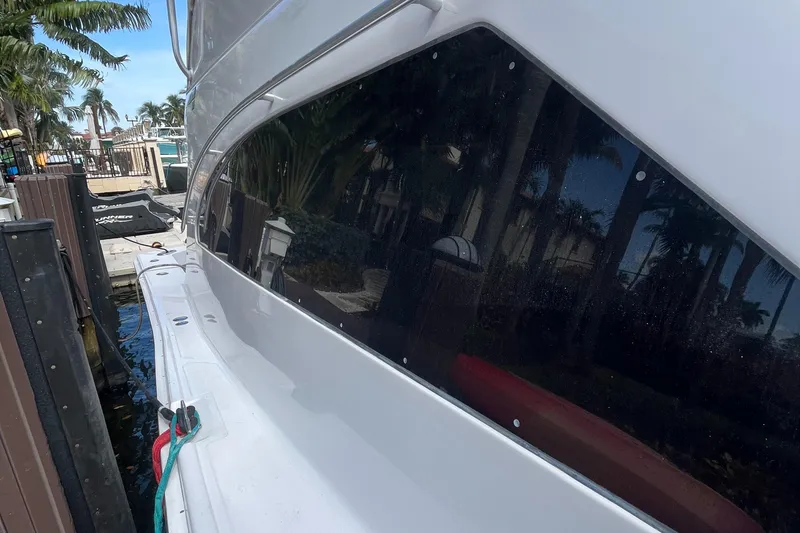 Slide: The Image of 2000 Luhrs Tournament 360 Convertible yacht docked near palm trees. - 25