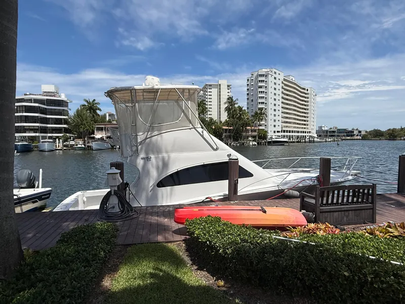 Slide: The Image of 2000 Luhrs Tournament 360 Convertible yacht docked by waterfront buildings. - 3