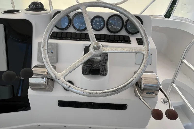 Slide: The Image of Steering wheel and controls of 2000 Luhrs Tournament 360 Convertible boat. - 32