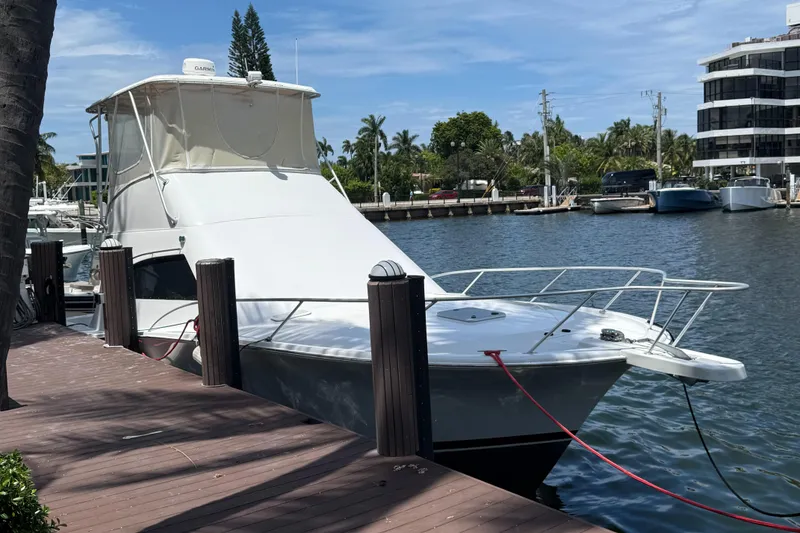 Slide: The Image of 2000 Luhrs Tournament 360 Convertible yacht docked by waterfront. - 4
