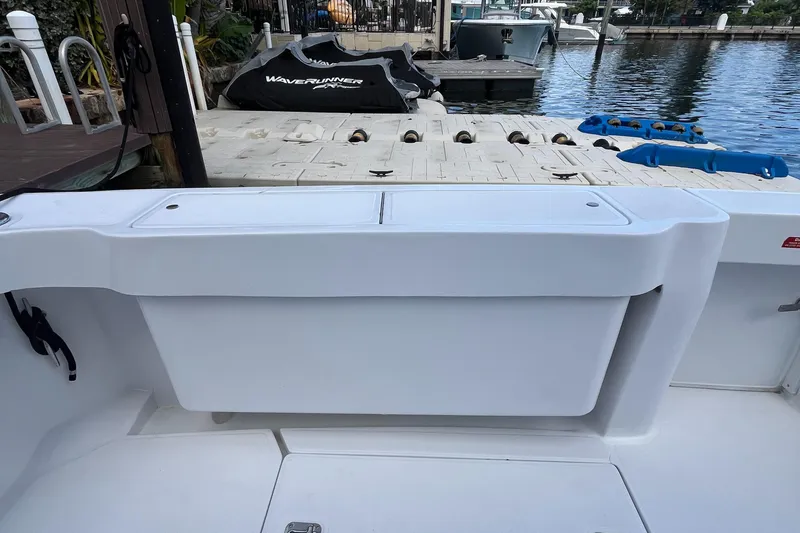 Slide: The Image of 2000 Luhrs Tournament 360 Convertible boat at dock with WaveRunner in background. - 45