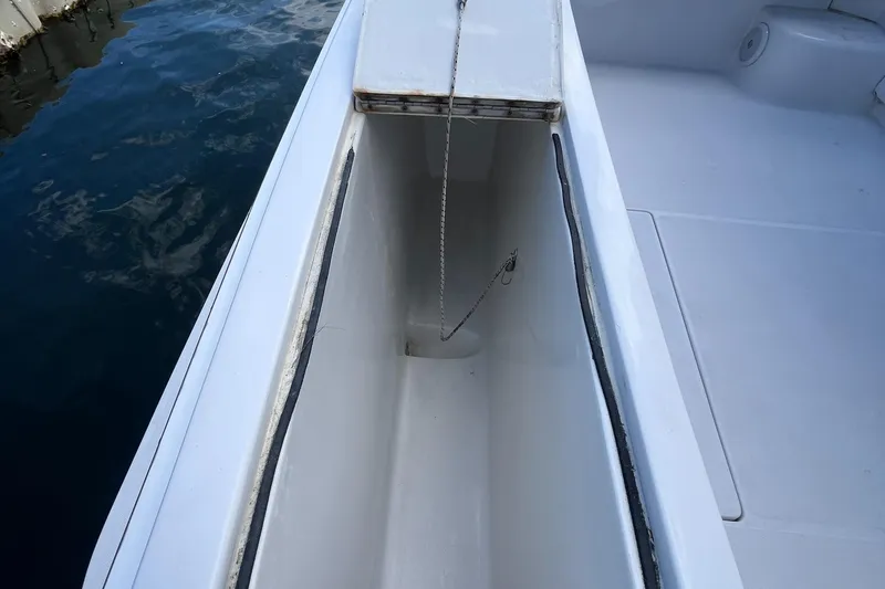 Slide: The Image of Open storage compartment on 2000 Luhrs Tournament 360 Convertible boat deck. - 49