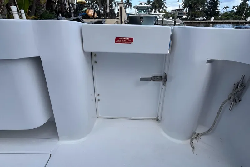 Slide: The Image of 2000 Luhrs Tournament 360 Convertible boat deck with a closed hatch and warning sign. - 50