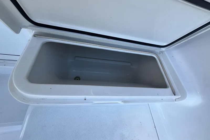 Slide: The Image of Open storage compartment on 2000 Luhrs Tournament 360 Convertible boat. - 52