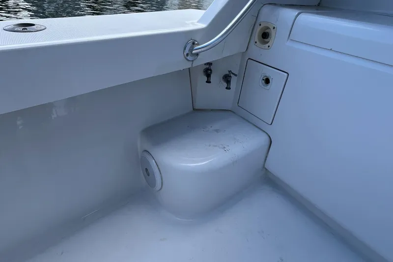 Slide: The Image of 2000 Luhrs Tournament 360 Convertible boat interior, featuring clean white surfaces and fixtures. - 57