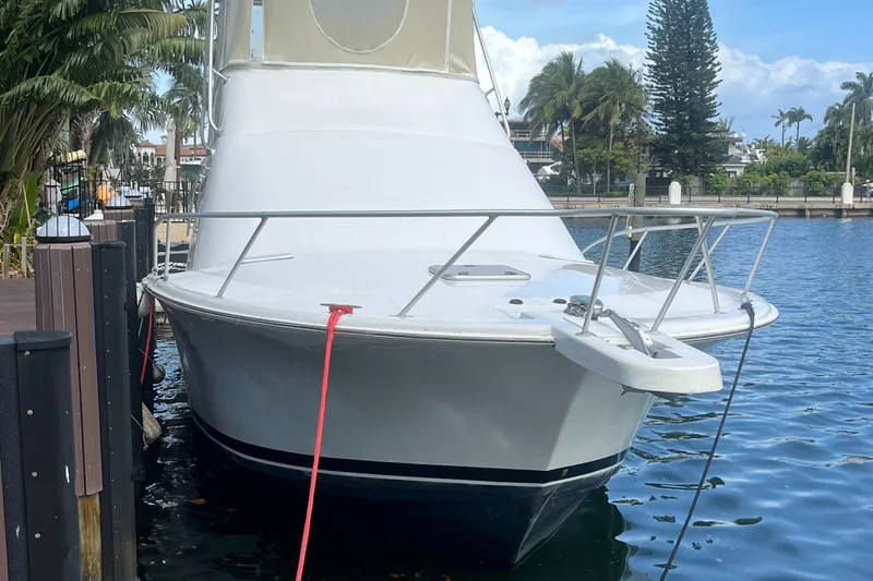 Slide: The Image of 2000 Luhrs Tournament 360 Convertible docked by palm trees and waterfront homes. - 6