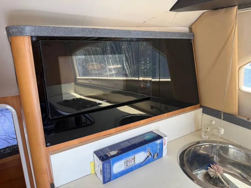 Slide: The Image of Interior of 2000 Luhrs Tournament 360 Convertible with microwave and sink. - 60