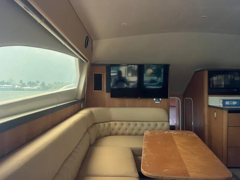 Slide: The Image of Interior of 2000 Luhrs Tournament 360 Convertible yacht with seating, table, and TV. - 63